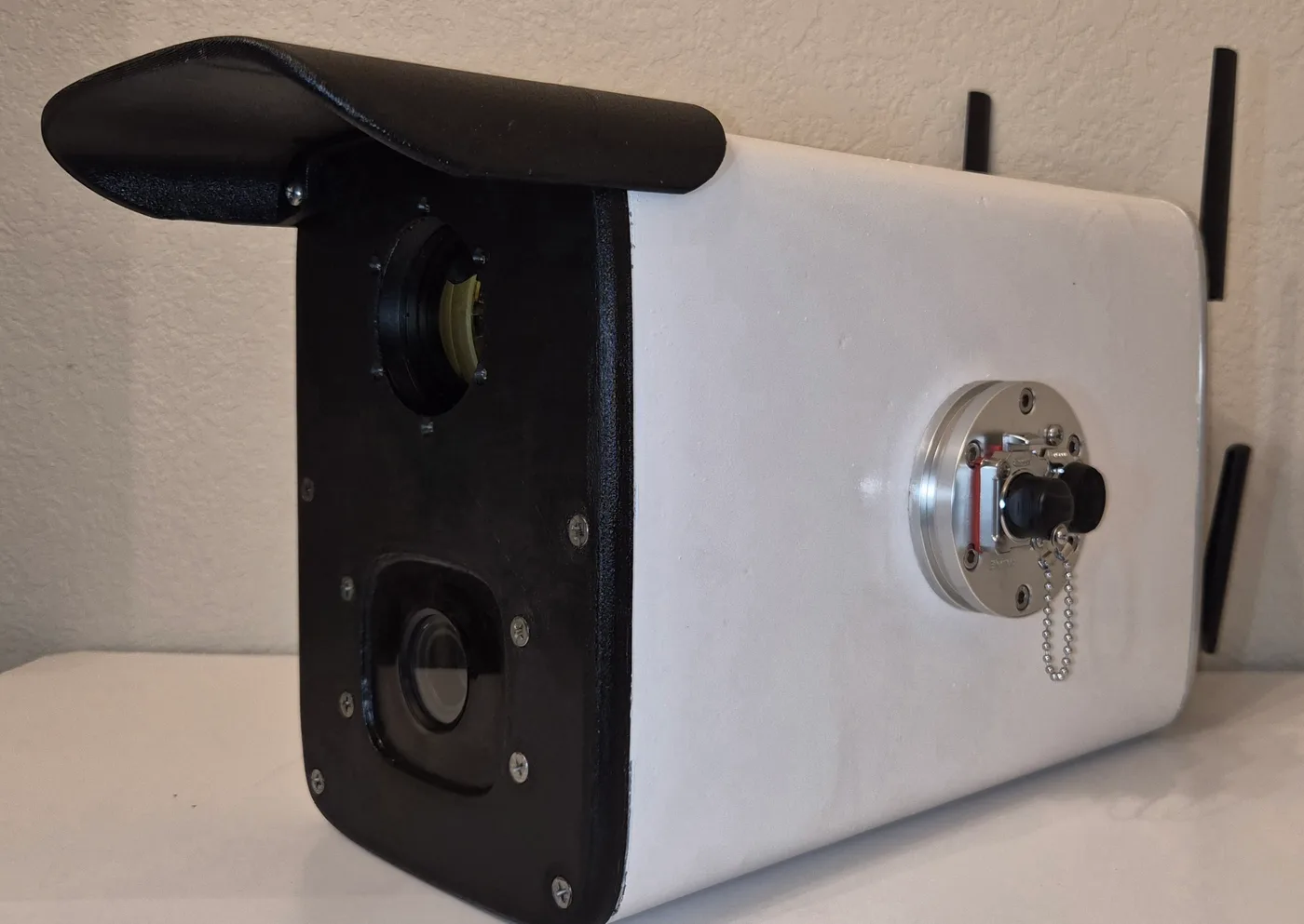 Three-quarter view of the Alta unit showing the dual-camera face, white enclosure, and connectivity antennas.