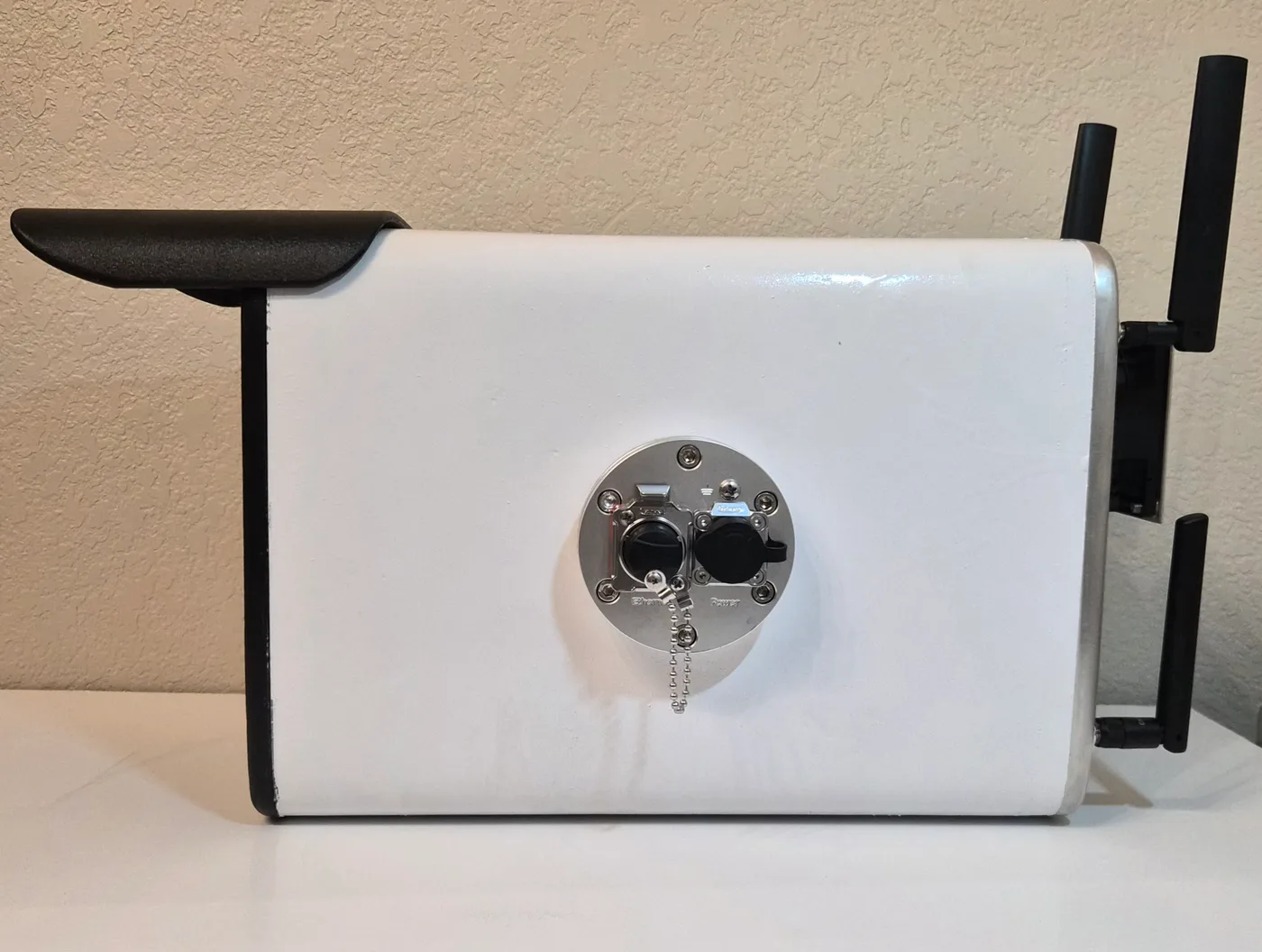 Side view of the Alta unit's sealed connector panel with weatherproof Ethernet and power connectors, and external antennas.
